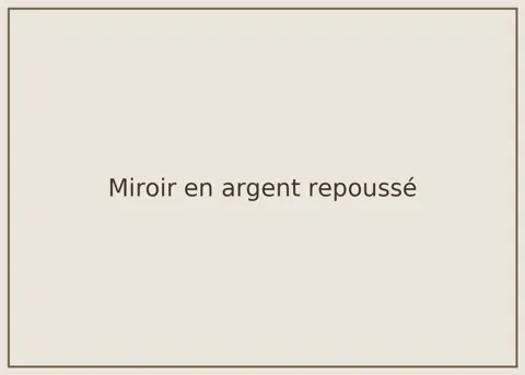 Repoussé silver mirror